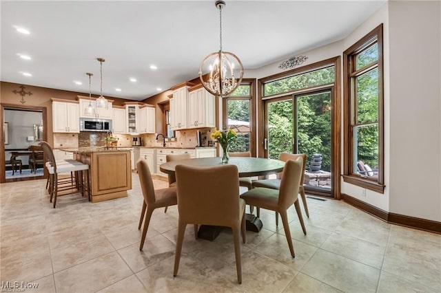 32305 Monaco Pl, Avon Lake, OH 44012 - dining room featuring a chandelier, light tile patterned flooring, and recessed lighting