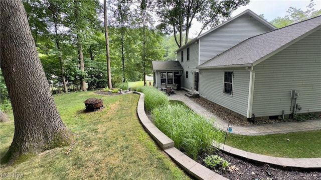 6190 3rd Ave, Kent, OH 44240 - view of green lawn with an outdoor fire pit and a patio area