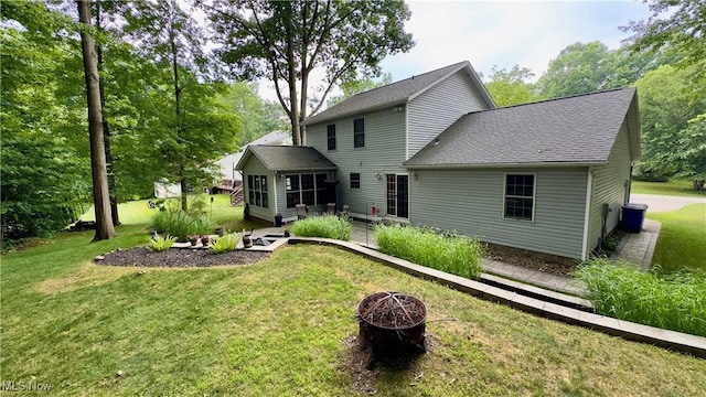 6190 3rd Ave, Kent, OH 44240 - back of house featuring a fire pit, a lawn, roof with shingles, a patio, and a sunroom