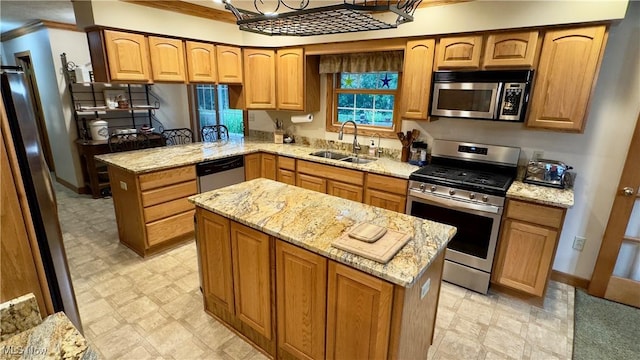 6190 3rd Ave, Kent, OH 44240 - kitchen featuring stainless steel appliances, light flooring, light stone counters, a kitchen island, and crown molding