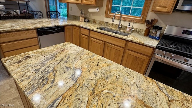 6190 3rd Ave, Kent, OH 44240 - kitchen featuring appliances with stainless steel finishes, light stone countertops, and brown cabinets