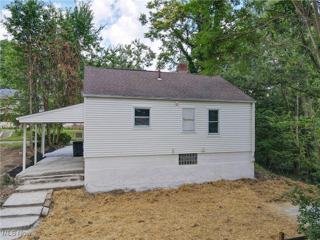 1672 Battery B St, Akron, OH 44305 - view of side of property with a shingled roof and a chimney