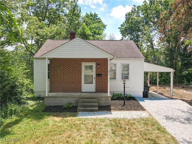 1672 Battery B St, Akron, OH 44305 - bungalow featuring a chimney, a carport, a shingled roof, gravel driveway, and a front yard