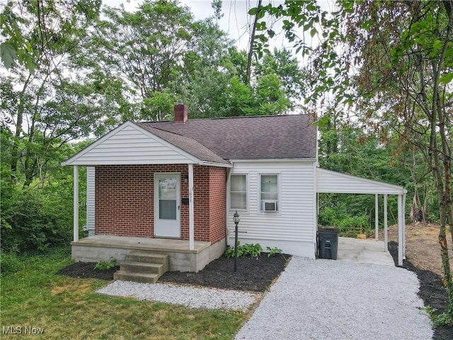 1672 Battery B St, Akron, OH 44305 - bungalow with a chimney, brick siding, gravel driveway, and roof with shingles