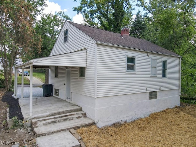 1672 Battery B St, Akron, OH 44305 - view of side of home featuring a chimney, a shingled roof, and a porch