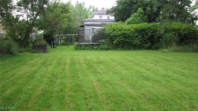 124 Hickory St, Andover, OH 44003 - view of green lawn featuring a trampoline