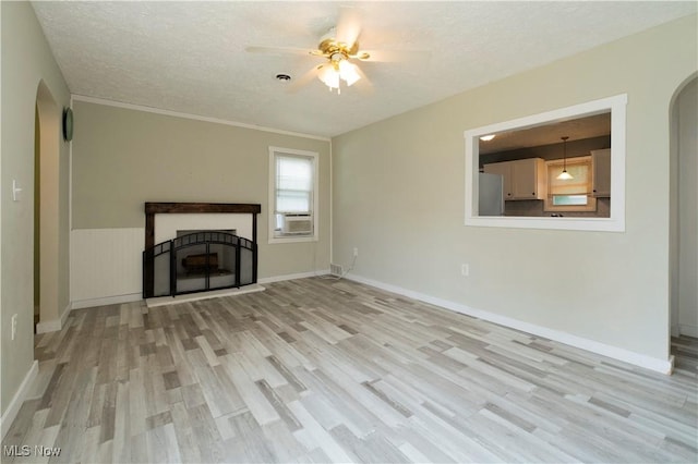 1214 E 360th St, Eastlake, OH 44095 - unfurnished living room with light wood-style flooring, arched walkways, ceiling fan, a textured ceiling, and a fireplace with raised hearth