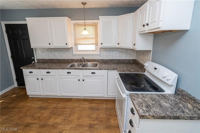 1214 E 360th St, Eastlake, OH 44095 - kitchen featuring white range with electric cooktop, dark countertops, decorative backsplash, and white cabinets