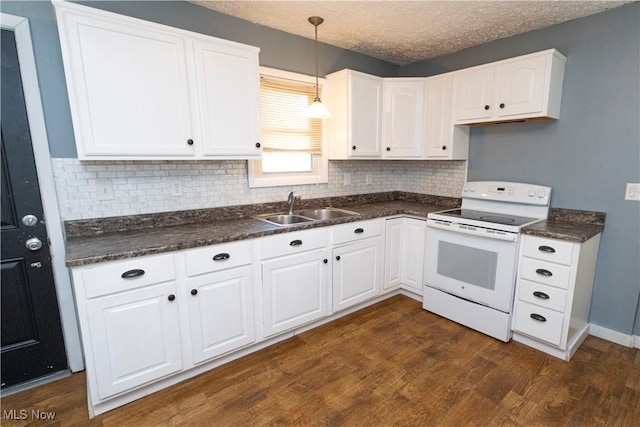 1214 E 360th St, Eastlake, OH 44095 - kitchen featuring electric stove, dark countertops, dark wood-type flooring, backsplash, and a textured ceiling