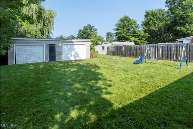 1214 E 360th St, Eastlake, OH 44095 - fenced backyard with a playground, an outbuilding, and a garage