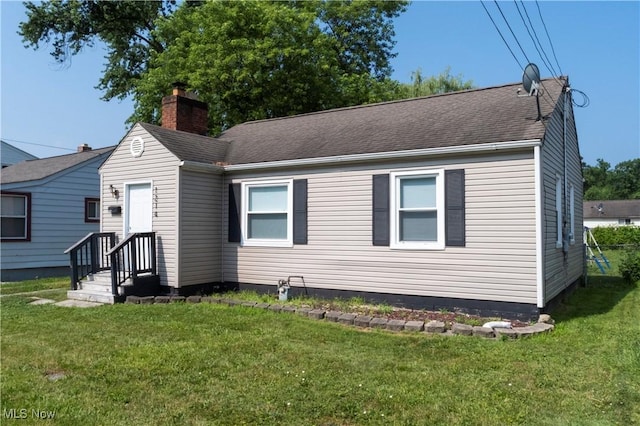 1214 E 360th St, Eastlake, OH 44095 - view of front of home with a front lawn, a chimney, and roof with shingles