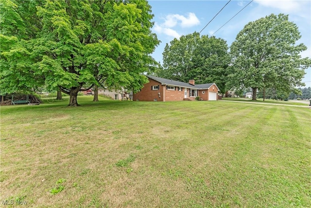 6767 Chippewa Ave NW, North Canton, OH 44720 - view of green lawn featuring a garage