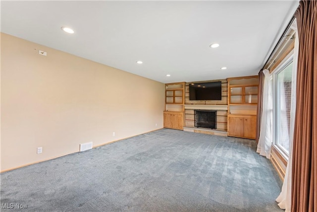 6767 Chippewa Ave NW, North Canton, OH 44720 - unfurnished living room with carpet, a large fireplace, healthy amount of natural light, and recessed lighting