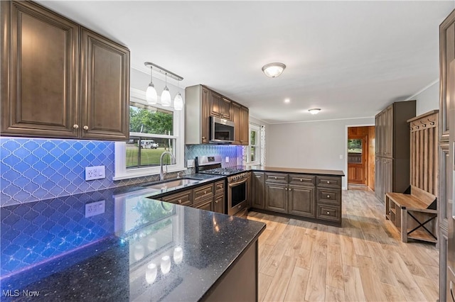 6767 Chippewa Ave NW, North Canton, OH 44720 - kitchen featuring appliances with stainless steel finishes, light wood finished floors, a peninsula, and plenty of natural light
