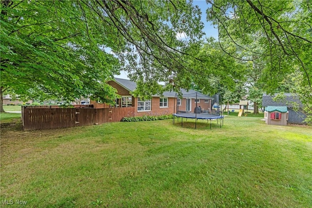 6767 Chippewa Ave NW, North Canton, OH 44720 - view of yard with a trampoline and a storage unit
