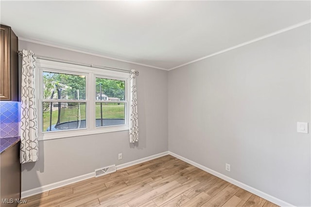 6767 Chippewa Ave NW, North Canton, OH 44720 - unfurnished room with light wood-style floors and ornamental molding
