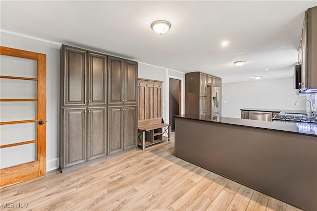 6767 Chippewa Ave NW, North Canton, OH 44720 - kitchen featuring appliances with stainless steel finishes, light wood-type flooring, and a peninsula