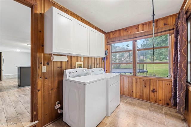 6767 Chippewa Ave NW, North Canton, OH 44720 - laundry room featuring cabinet space, separate washer and dryer, and wooden walls