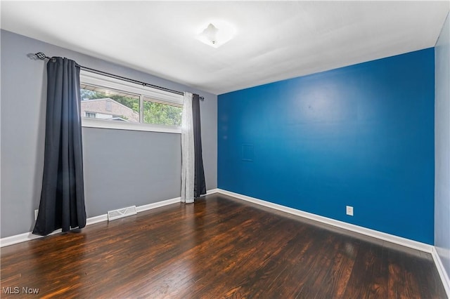 6767 Chippewa Ave NW, North Canton, OH 44720 - spare room featuring wood finished floors and baseboards