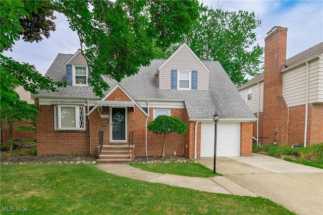 29504 Cresthaven Dr, Willowick, OH 44095 - new england style home featuring brick siding, driveway, a front yard, a shingled roof, and a garage