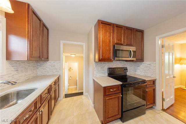 29504 Cresthaven Dr, Willowick, OH 44095 - kitchen featuring stainless steel microwave, black electric range oven, backsplash, and brown cabinets