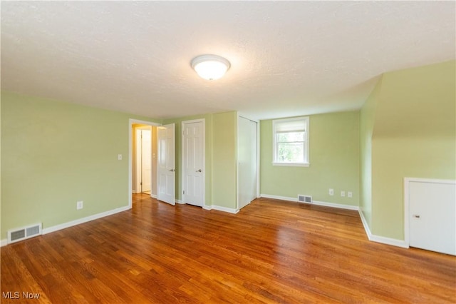 29504 Cresthaven Dr, Willowick, OH 44095 - unfurnished bedroom with wood finished floors, two closets, and a textured ceiling