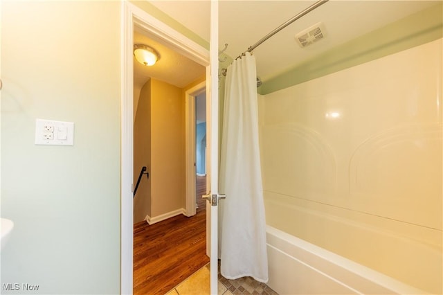 29504 Cresthaven Dr, Willowick, OH 44095 - bathroom with shower / tub combo with curtain and wood finished floors