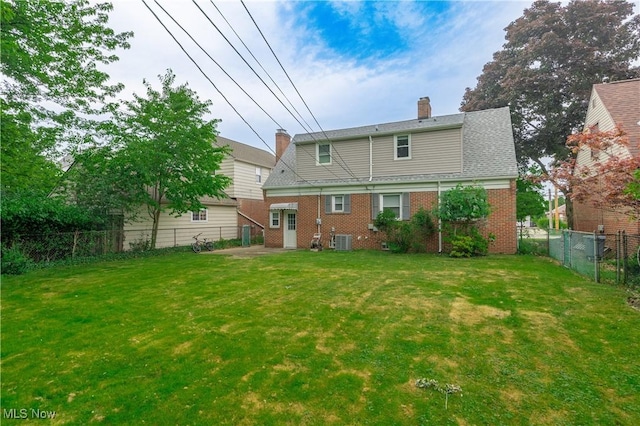 29504 Cresthaven Dr, Willowick, OH 44095 - back of property featuring a fenced backyard, brick siding, and a chimney