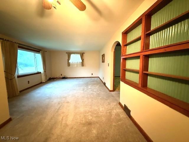 5783 Eagle Creek Rd, Leavittsburg, OH 44430 - carpeted spare room featuring arched walkways and a ceiling fan