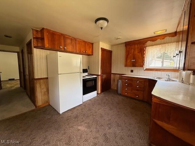 5783 Eagle Creek Rd, Leavittsburg, OH 44430 - kitchen featuring white appliances, brown cabinets, dark colored carpet, light countertops, and radiator
