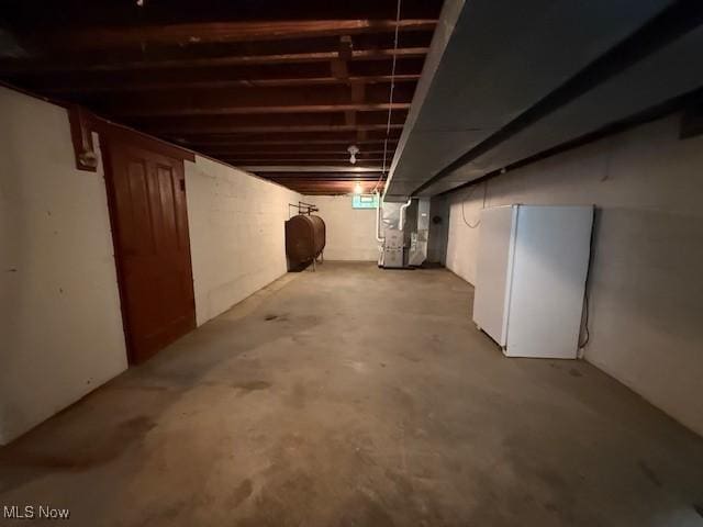 5783 Eagle Creek Rd, Leavittsburg, OH 44430 - unfinished below grade area with heating fuel, freestanding refrigerator, and heating unit