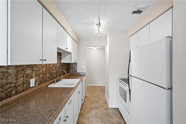 21881 River Oaks Dr Unit C4, Rocky River, OH 44116 - kitchen with white appliances, tasteful backsplash, dark countertops, and white cabinetry