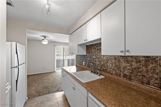 21881 River Oaks Dr Unit C4, Rocky River, OH 44116 - kitchen featuring freestanding refrigerator, a ceiling fan, white cabinets, decorative backsplash, and light carpet