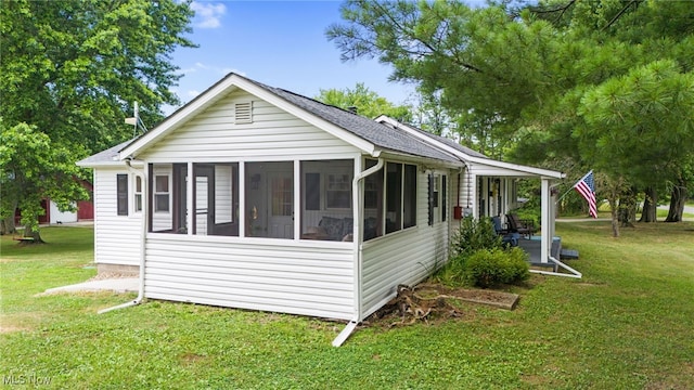 6062 Trask Rd, Thompson, OH 44086 - view of home's exterior featuring a sunroom, a yard, and roof with shingles