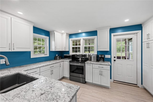 6062 Trask Rd, Thompson, OH 44086 - kitchen with electric stove, white cabinetry, and recessed lighting