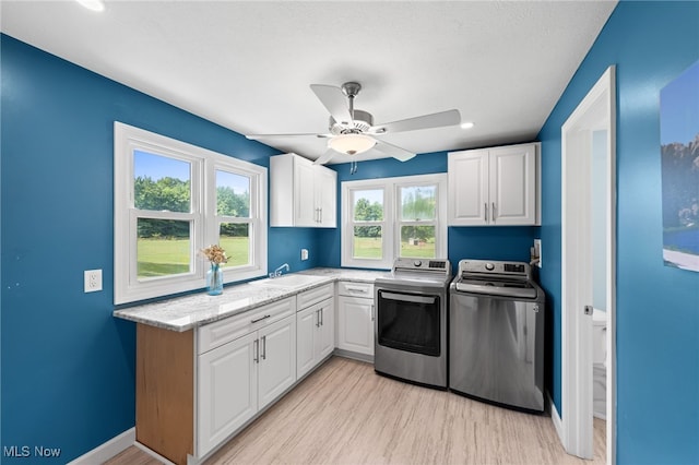 6062 Trask Rd, Thompson, OH 44086 - washroom featuring cabinet space, separate washer and dryer, light wood-style flooring, a ceiling fan, and recessed lighting