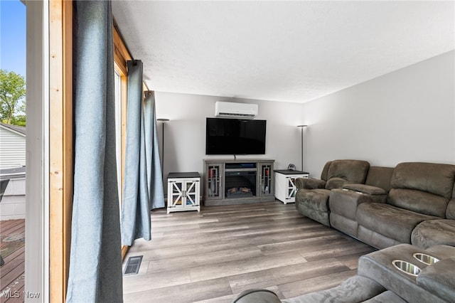 6062 Trask Rd, Thompson, OH 44086 - living room with a wall unit AC and wood finished floors