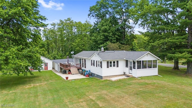 6062 Trask Rd, Thompson, OH 44086 - rear view of property with a sunroom, a patio, a lawn, and roof with shingles