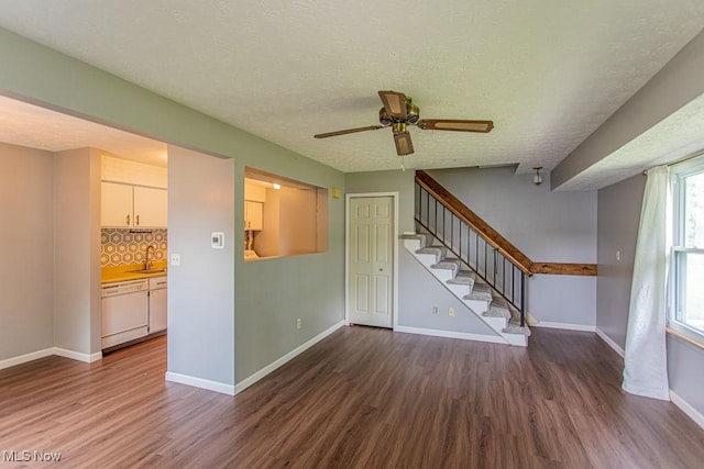 3062 Ivy Hill Cir Unit D, Cortland, OH 44410 - unfurnished living room featuring wood finished floors, stairway, ceiling fan, and a textured ceiling