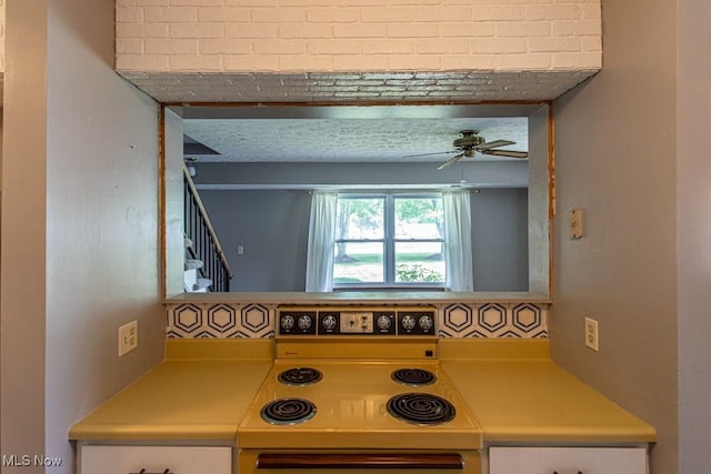 3062 Ivy Hill Cir Unit D, Cortland, OH 44410 - kitchen with white electric stove, light countertops, and ceiling fan