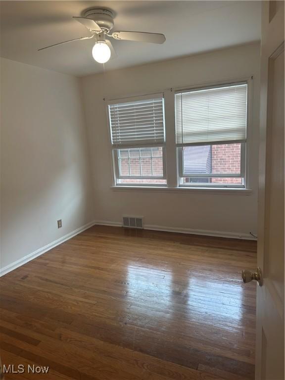 13698 Cedar, University Heights, OH 44118 - empty room featuring wood finished floors and ceiling fan