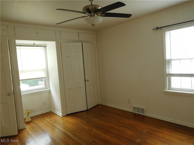 13698 Cedar, University Heights, OH 44118 - unfurnished bedroom with multiple windows, wood finished floors, a closet, and a ceiling fan