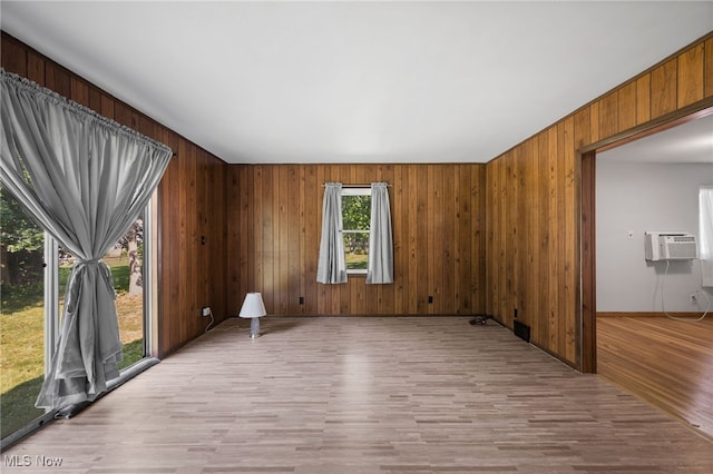 4031 Suffolk Rd, South Euclid, OH 44121 - spare room with light wood finished floors, an AC wall unit, and wood walls