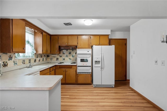 4031 Suffolk Rd, South Euclid, OH 44121 - kitchen with white appliances, a warming drawer, light countertops, and light wood-type flooring