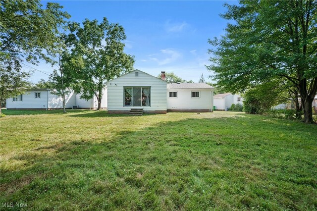 4031 Suffolk Rd, South Euclid, OH 44121 - back of property featuring a lawn and entry steps