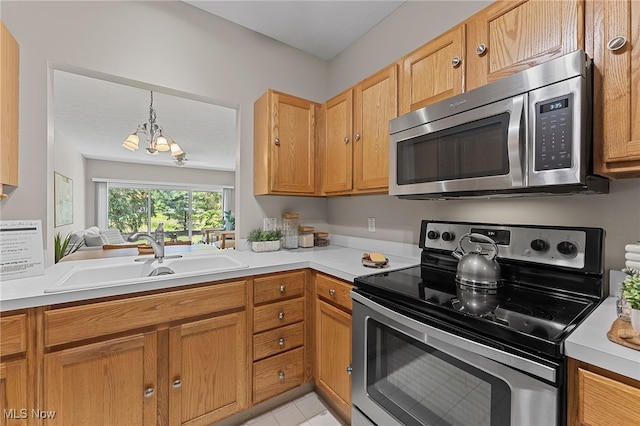 33972 Honeysuckle Ln, North Ridgeville, OH 44039 - kitchen with appliances with stainless steel finishes, a chandelier, light countertops, light tile patterned flooring, and decorative light fixtures