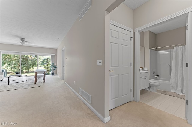 33972 Honeysuckle Ln, North Ridgeville, OH 44039 - hall with light colored carpet, light tile patterned floors, and a textured ceiling