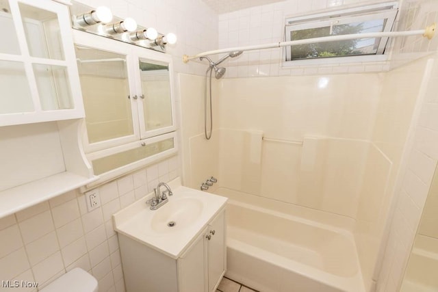 4011 Lancaster Rd, South Euclid, OH 44121 - bathroom featuring  shower combination, vanity, and tile walls