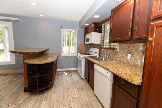 4011 Lancaster Rd, South Euclid, OH 44121 - kitchen with white appliances, tasteful backsplash, light wood-style flooring, recessed lighting, and a textured ceiling