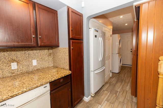 4011 Lancaster Rd, South Euclid, OH 44121 - kitchen with stacked washer / drying machine, white appliances, backsplash, arched walkways, and recessed lighting